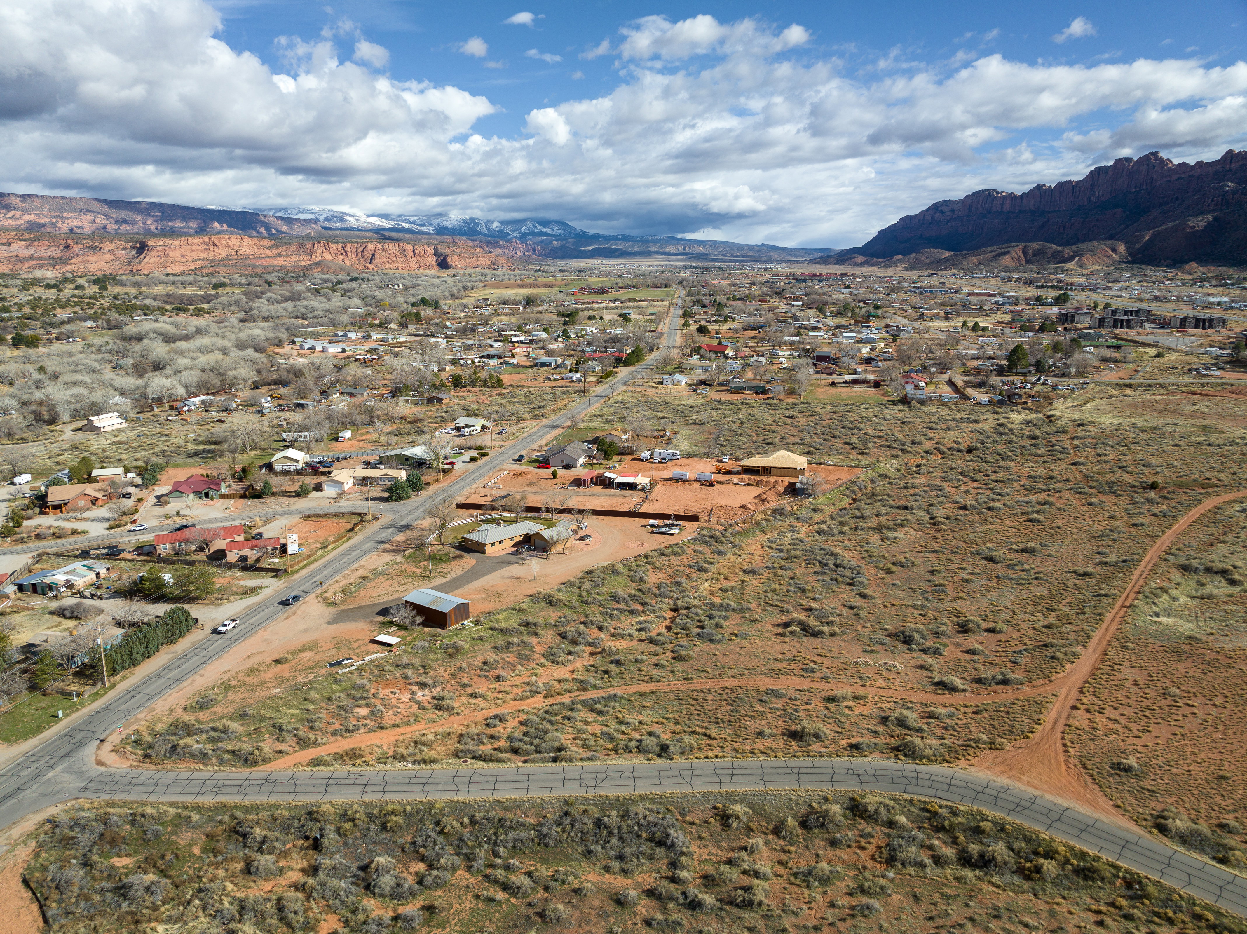 Aerial view of property and surrounding area with a mountainous background and rural landscape