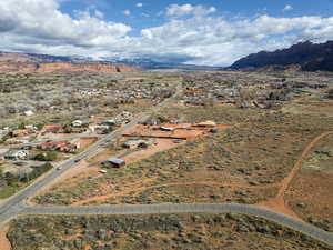 Aerial view of property and surrounding area with a mountainous background and rural landscape