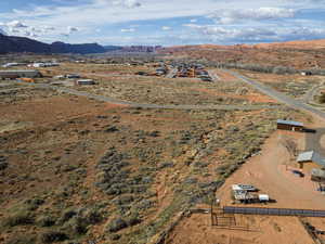 Aerial view of sparsely populated area with a mountainous background and a desert landscape