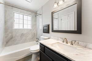 Full bath with vanity and shower / bath combination