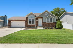 View of front of home featuring brick siding, an attached garage, concrete driveway, and entry steps