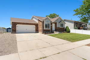 Ranch-style home with a garage, concrete driveway, brick siding, a gate, and roof with shingles