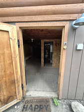 Doorway to property featuring water heater