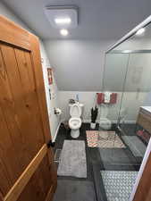 Bathroom with lofted ceiling and a shower stall