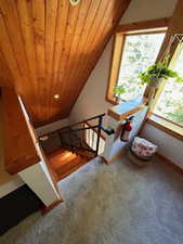 Bonus room with wood ceiling, vaulted ceiling, and carpet floors