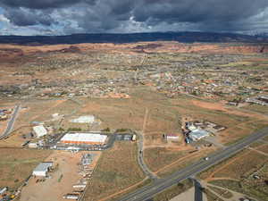 Aerial view of property and surrounding area featuring rural landscape and a mountainous background
