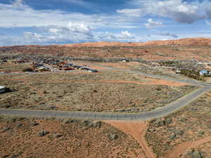 Aerial view of sparsely populated area with a desert landscape and a mountainous background