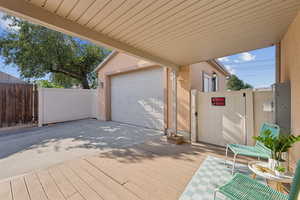 Deck with a gate and concrete driveway