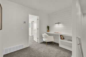 Home office featuring light carpet