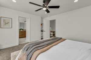 Carpeted bedroom featuring recessed lighting, a ceiling fan, and ensuite bathroom