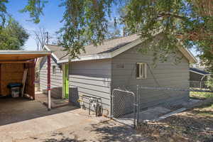 View of outbuilding with a gate
