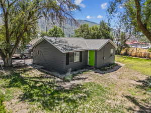 View of home's exterior featuring a mountain view and roof with shingles