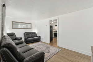 Living room featuring a textured ceiling and light wood-type flooring