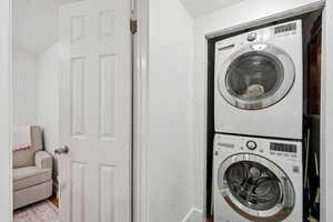 Laundry room featuring stacked washer / drying machine