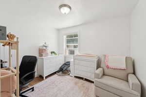 Office featuring wood finished floors and a textured ceiling