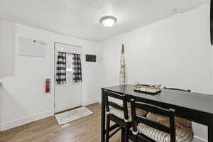 Dining area with a textured ceiling and light wood-type flooring