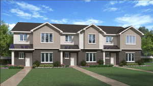 View of front of house featuring a front lawn, brick siding, a metal roof, and a standing seam roof