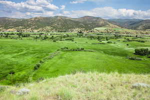 View of mountain backdrop with rural landscape and a pastoral area