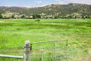 View of mountain backdrop featuring rural landscape