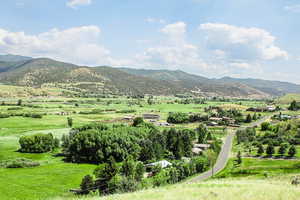 View of mountain backdrop with rural landscape