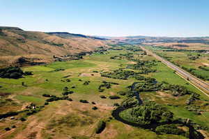 Aerial view of property and surrounding area with rural landscape and mountains