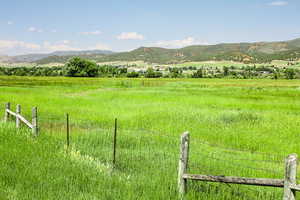 View of mountain background with rural landscape and agricultural land