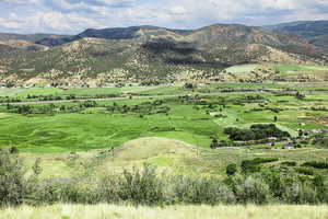 View of mountain backdrop featuring rural landscape