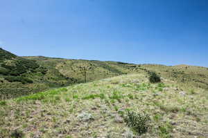 View of mountain backdrop with rural landscape