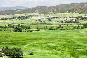 View of mountain backdrop with rural landscape