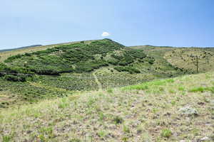 View of mountain backdrop featuring rural landscape