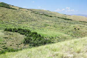 View of mountain backdrop featuring rural landscape