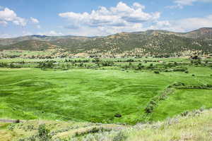 View of mountain background featuring rural landscape and agricultural land