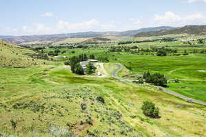 Aerial view of sparsely populated area featuring a mountain backdrop and a pastoral area