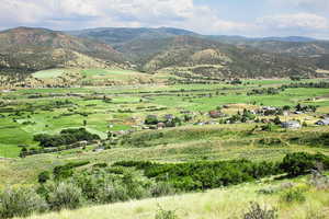 View of mountain backdrop with rural landscape and a pastoral area