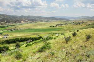 View of mountain backdrop featuring rural landscape