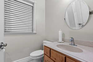 Bathroom featuring vanity and toilet