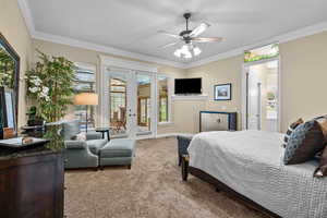 Carpeted bedroom featuring french doors, access to outside, ornamental molding, and a ceiling fan