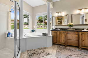 Full bathroom featuring double vanity, a shower stall, a garden tub, ornate columns, and tile patterned flooring
