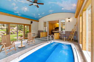 View of pool with a ceiling fan, a pool, and a patio area