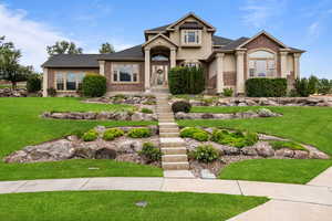 Craftsman-style house featuring brick siding, a front yard, and a shingled roof