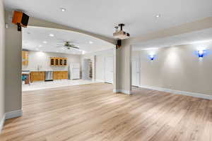 Unfurnished living room featuring light wood-style floors, ceiling fan, and recessed lighting