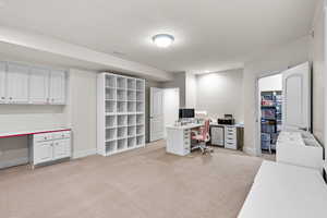 Office area with light colored carpet and baseboards
