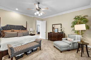 Carpeted bedroom with crown molding, a ceiling fan, and recessed lighting