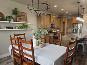 Dining room featuring dark wood-style floors and recessed lighting