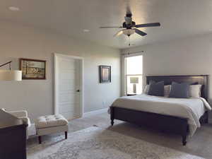 Carpeted bedroom with baseboards and ceiling fan