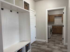 Mudroom featuring washer and clothes dryer and wood finished floors