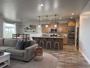 Living room featuring a textured ceiling, wood finished floors, and recessed lighting