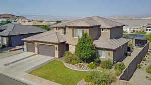 View of front of property featuring stucco siding, a garage, a residential view, concrete driveway, and a tile roof