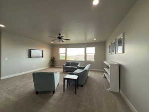 Living area featuring carpet, recessed lighting, and ceiling fan