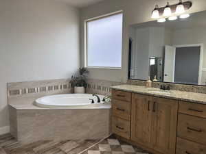 Bathroom featuring vanity and a bath